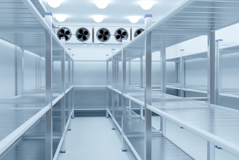 Large walk in cold room 1 Empty cold storage room with metal shelving and ceiling-mounted evaporator units
